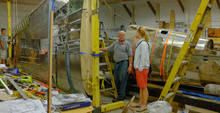 Julie chatting with Art Wilder (a restoration volunteer) about the P-40 restoration project