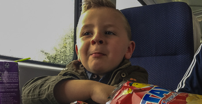 Our train buddy, eating a bag of delicious cheese and onion Tayto crisps