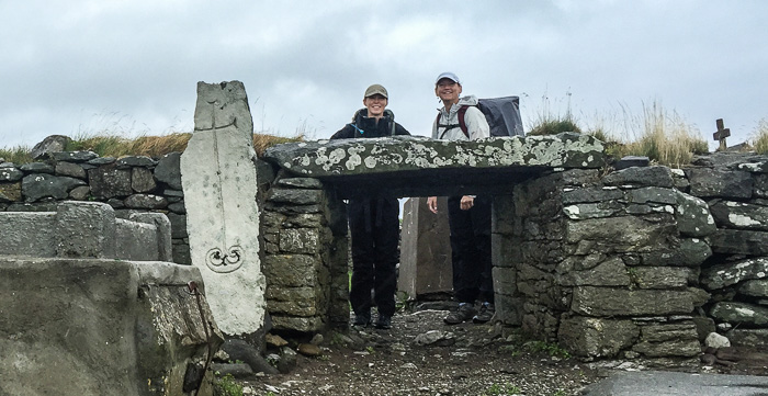 Julie and Karen with a seventh century cross slab in a cemetery in Kilshannig