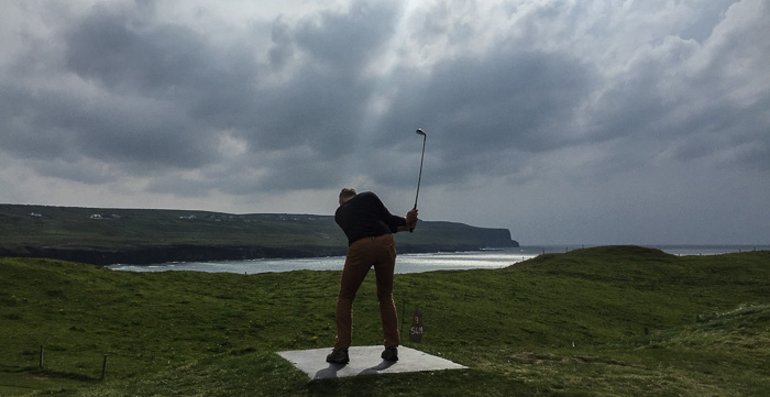 Chris golfing on the Doolin Pitch and Putt. That's the Cliffs of Moher in the background!