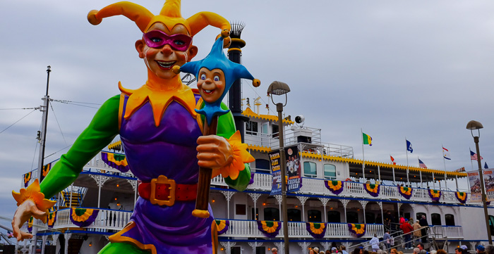 A Mardi Gras jester welcomes one and all to board the Creole Queen