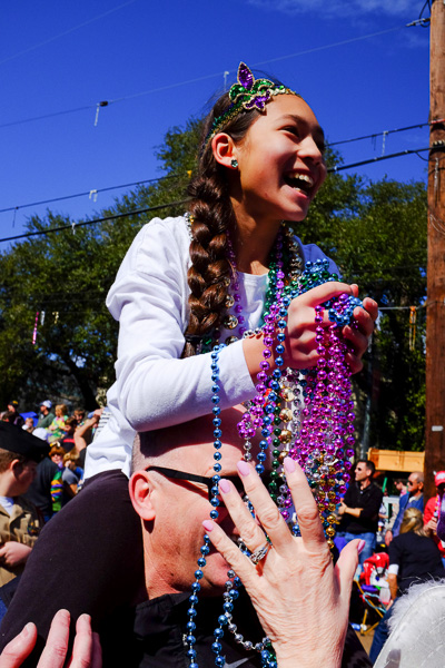 This young lady's teacher was riding a float so Jack gave her a boost, we all screamed like madmen, and beads came raining down.
