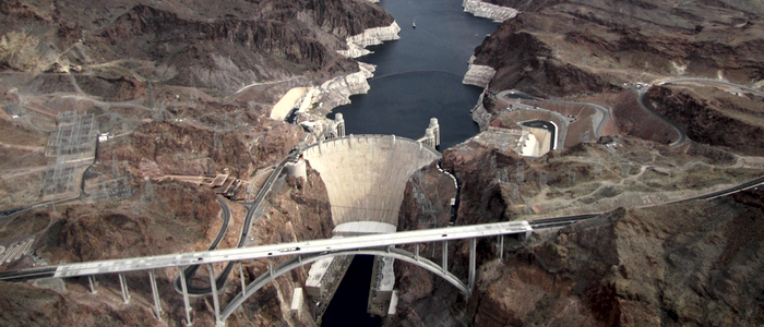 An aerial view of Hoover Dam with the newer Memorial Bridge in the foreground (MorgueFile photo)