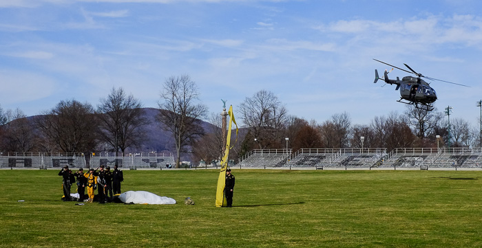 Member of the West Point parachute team, all safely landed. The one in yellow is the Plebe who just completed his first jump.