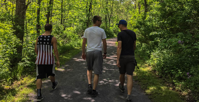 The guys walking towards the waterfall on the Keuka Outlet Trail