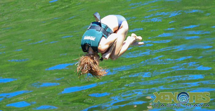 Julie attempting a backflip off the ziplane. Not. gonna. make. it. Photo by Jaime of Xenotes Oasis Maya.