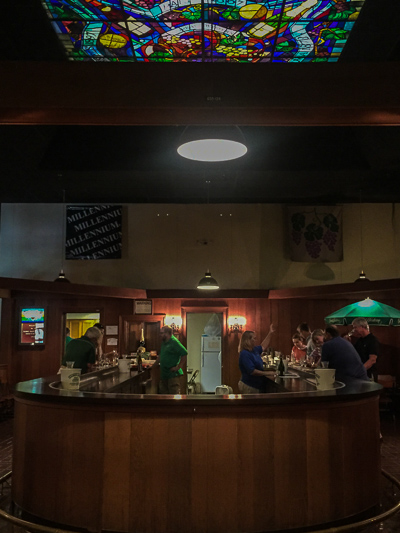 The Pleasant Valley wine tasting bar with redwood below and stained glass above.