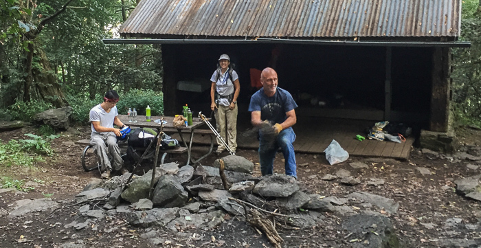 Busy morning at Calf Mountain Shelter. That's Mike digging out the fire pit. Chris (not pictured) is weed-whacking nearby.