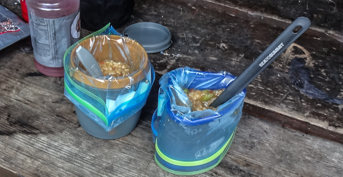Dinner with no clean-up! These are freezer-quality bags (regular bags can't handle boiling water) and the mugs provide much-needed structure (it's awkward to eat straight from a plastic bag).