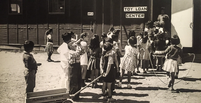 Making the most of limited resources: Children in line at Manzanar's Toy Loan Center. This is a photo of a photo displayed in the Manzanar Visitor Center.