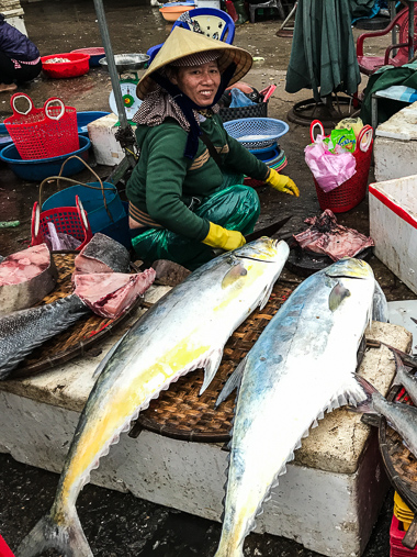 Cleaning fresh yellowfin tuna at the Dong Hoi market.