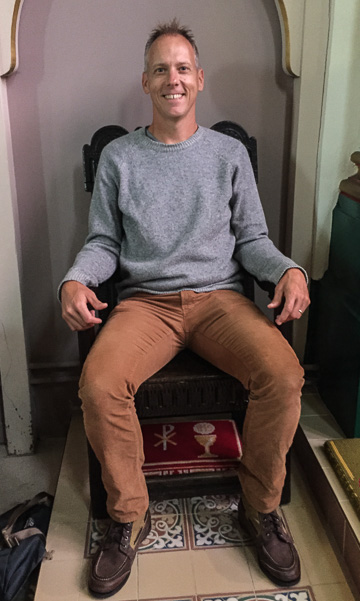 Chris sitting in King William's chair in St. George's Church