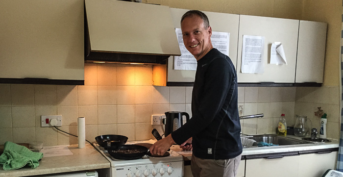 Chris cooking breakfast in the community kitchen in the Castle Hostel in Ballycastle
