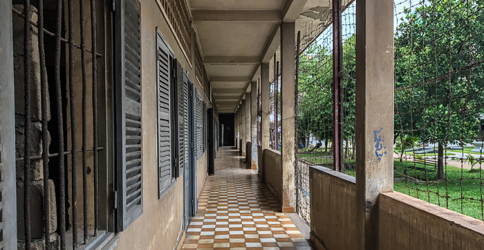 One of the buildings at Tuol Sleng, a former high school. Many school rooms (on the left) were used for interrogation. Others were further subdivided with brick or wood into cramped, single-person prison cells.