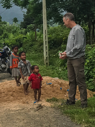 Chris handing out treats to some of the village kids. He ran out right before the little guy in red ran up. The boy turned away, face crumpled and tears starting to flow when Bang discovered a lone moon pie tucked away in his bags. Crisis averted!